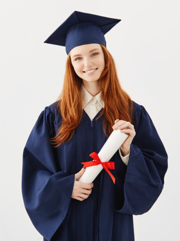 happy-ginger-graduate-woman-cap-mantle-smiling-holding-diploma